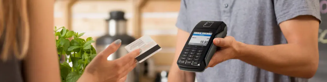 Kartenzahlung einer blonden Frau über das myPOS Combo in Schwarz, Mobiles POS Terminal der Kassenhardware des Kassensystems